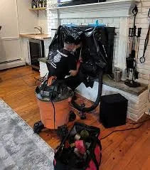 Fireplace cleaning setup with vacuum equipment and protective containment